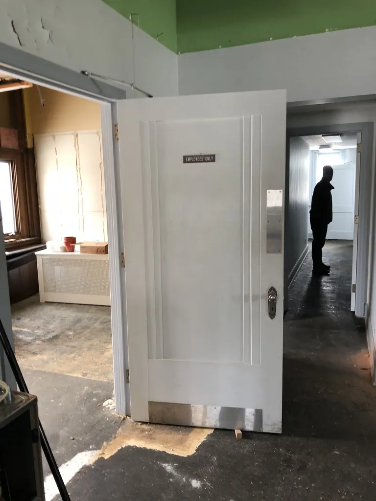 An old Employees Only door in the gutted interior