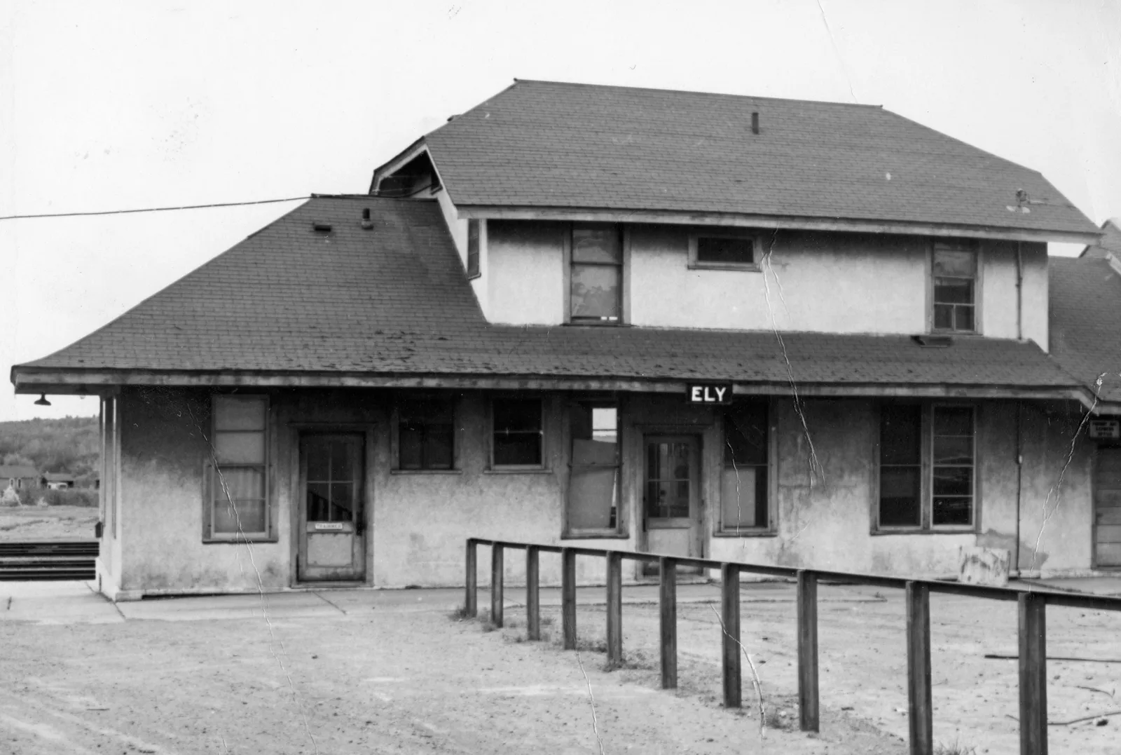 The stucco depot with a wooden platform railing and ELY sign