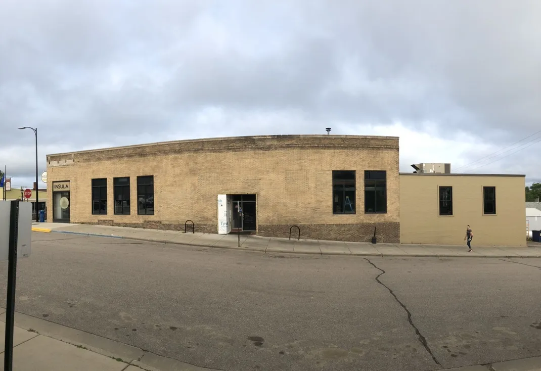 Panorama of the restored brick building along the side street