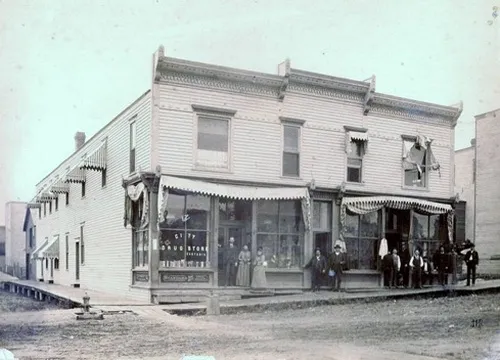 Staff posing in front of the City Drug Store