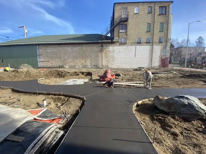 Workers finishing where the new concrete paths meet