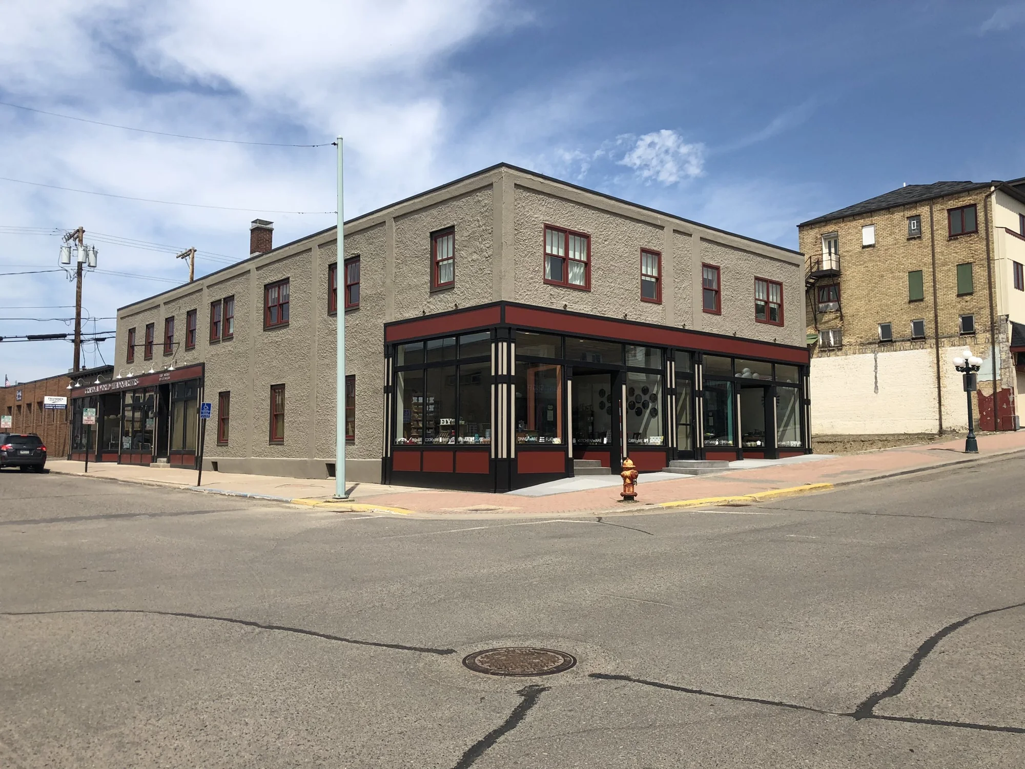 Restored two-story corner building with red-trimmed storefront windows in downtown Ely