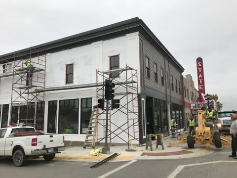 New siding and trim going up at the corner next to the State sign