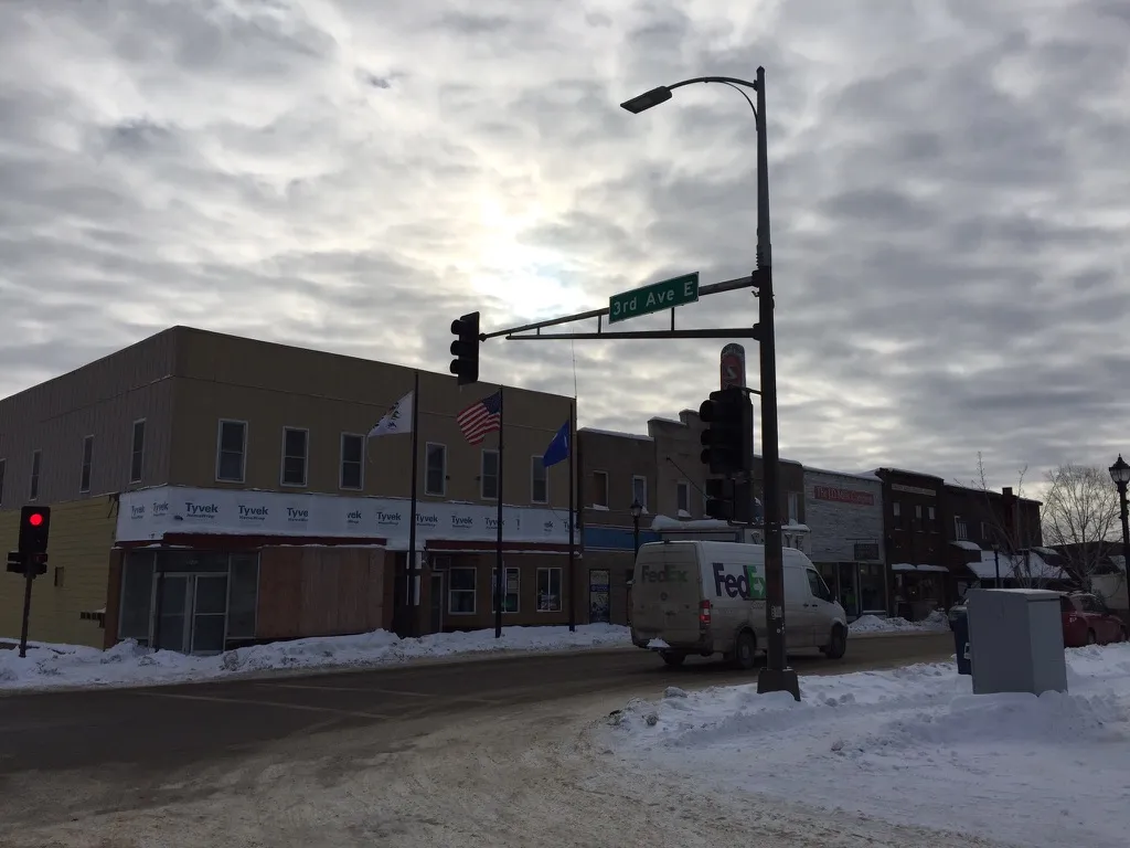 The building wrapped in house wrap in winter at the corner of Sheridan and 3rd Avenue East