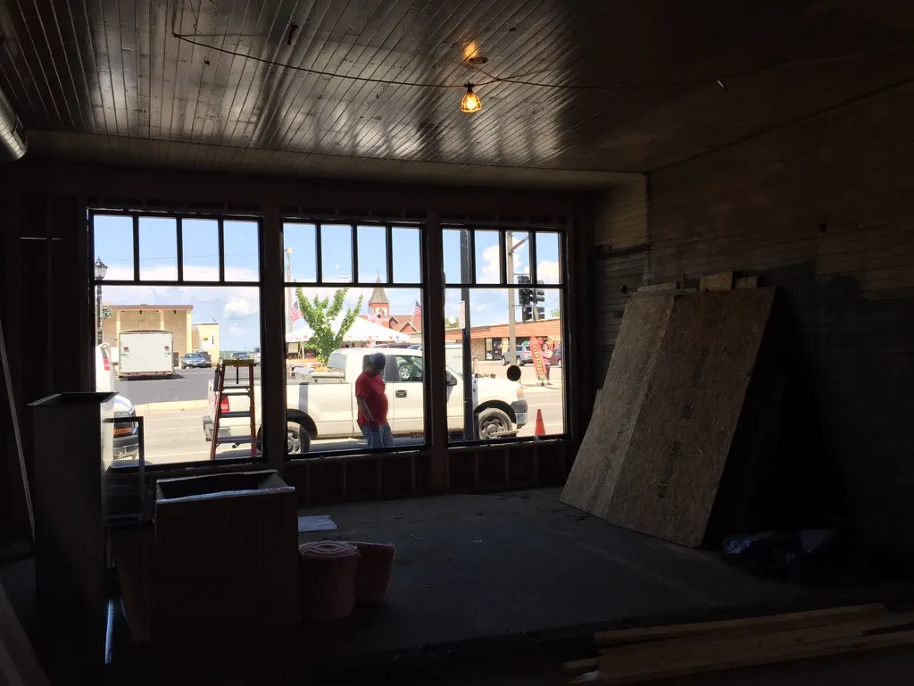 Looking out through the new storefront windows at Sheridan Street from the dim interior