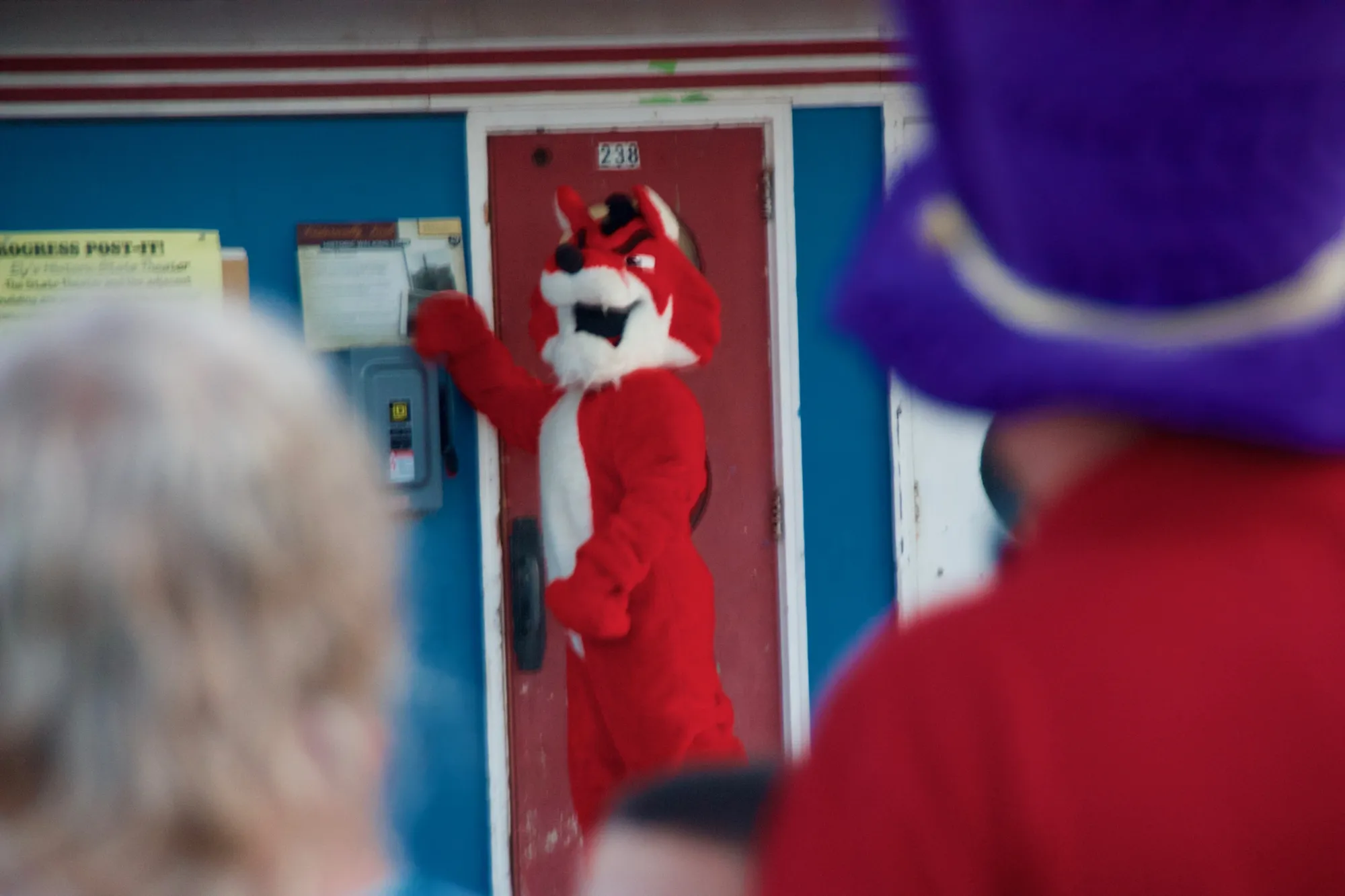 The mascot at the theater's red door marked 238