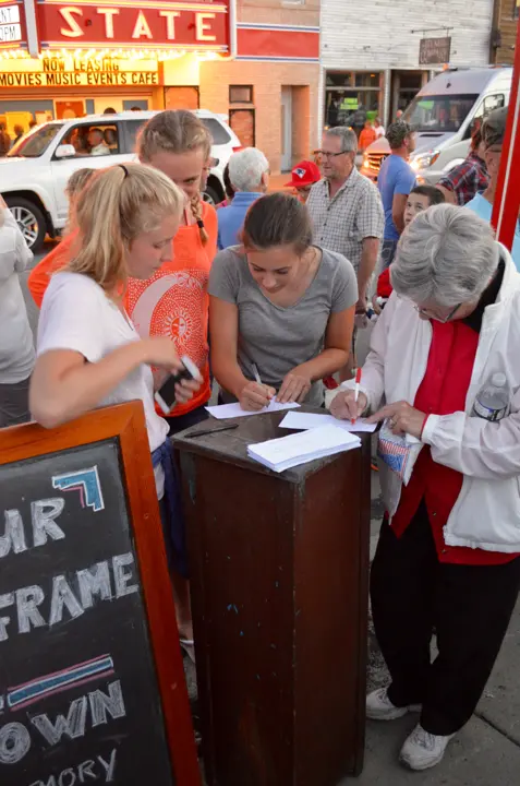 Guests writing memories of the State Theater on cards at a small stand