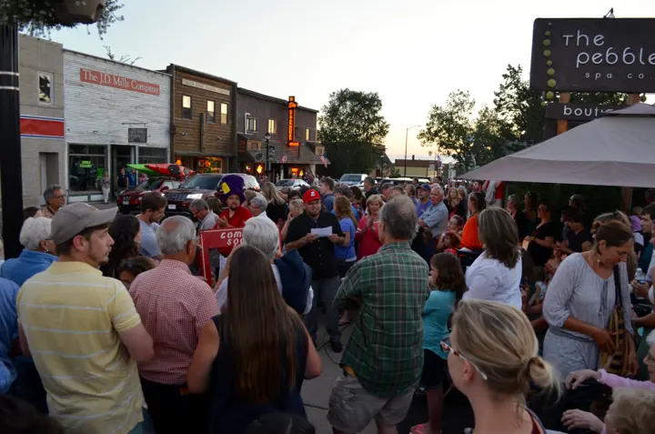 A crowd gathered on Sheridan Street listening to a speaker before the lighting