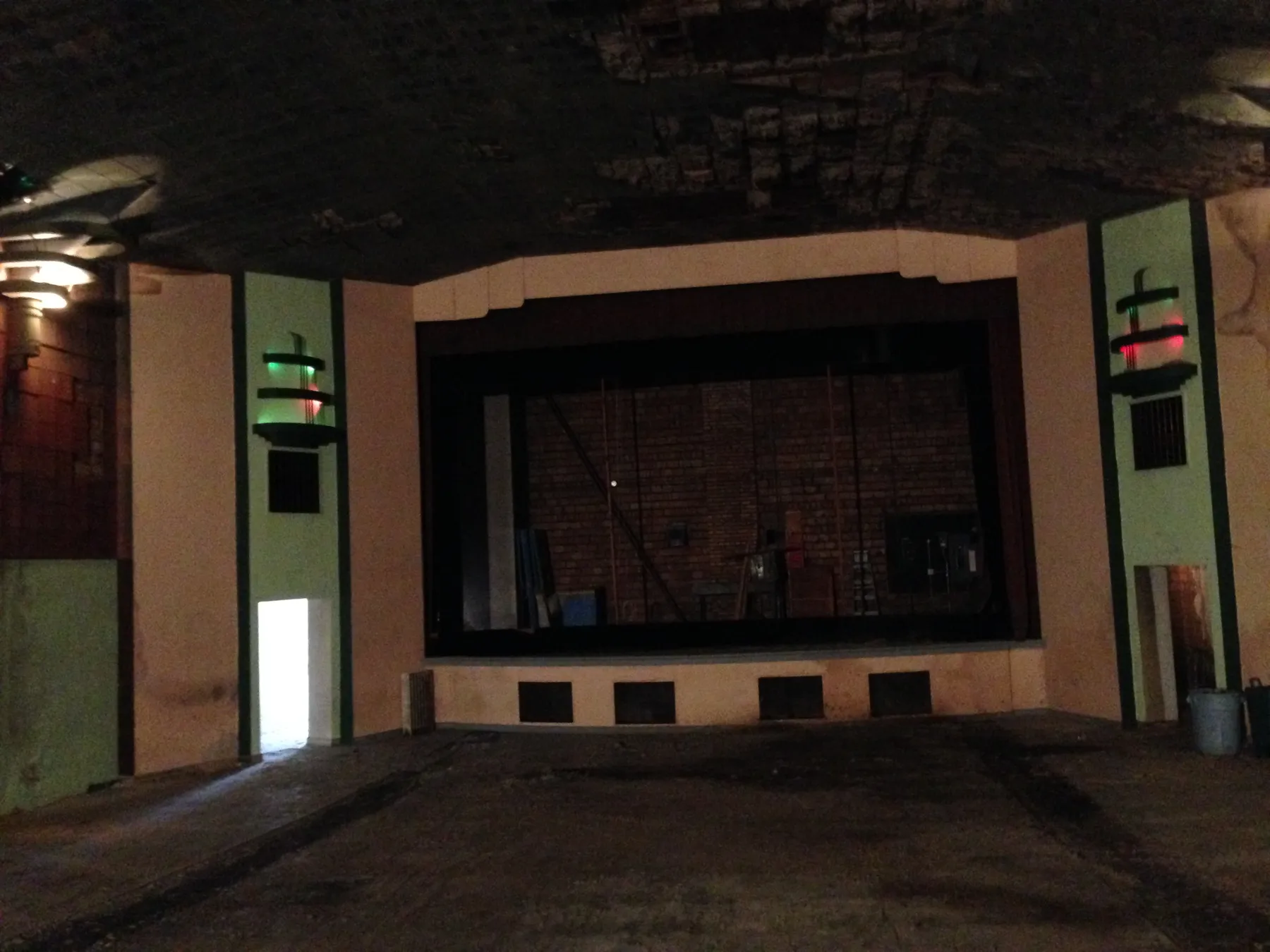 The stage with red and green lit Art Deco light towers on either side